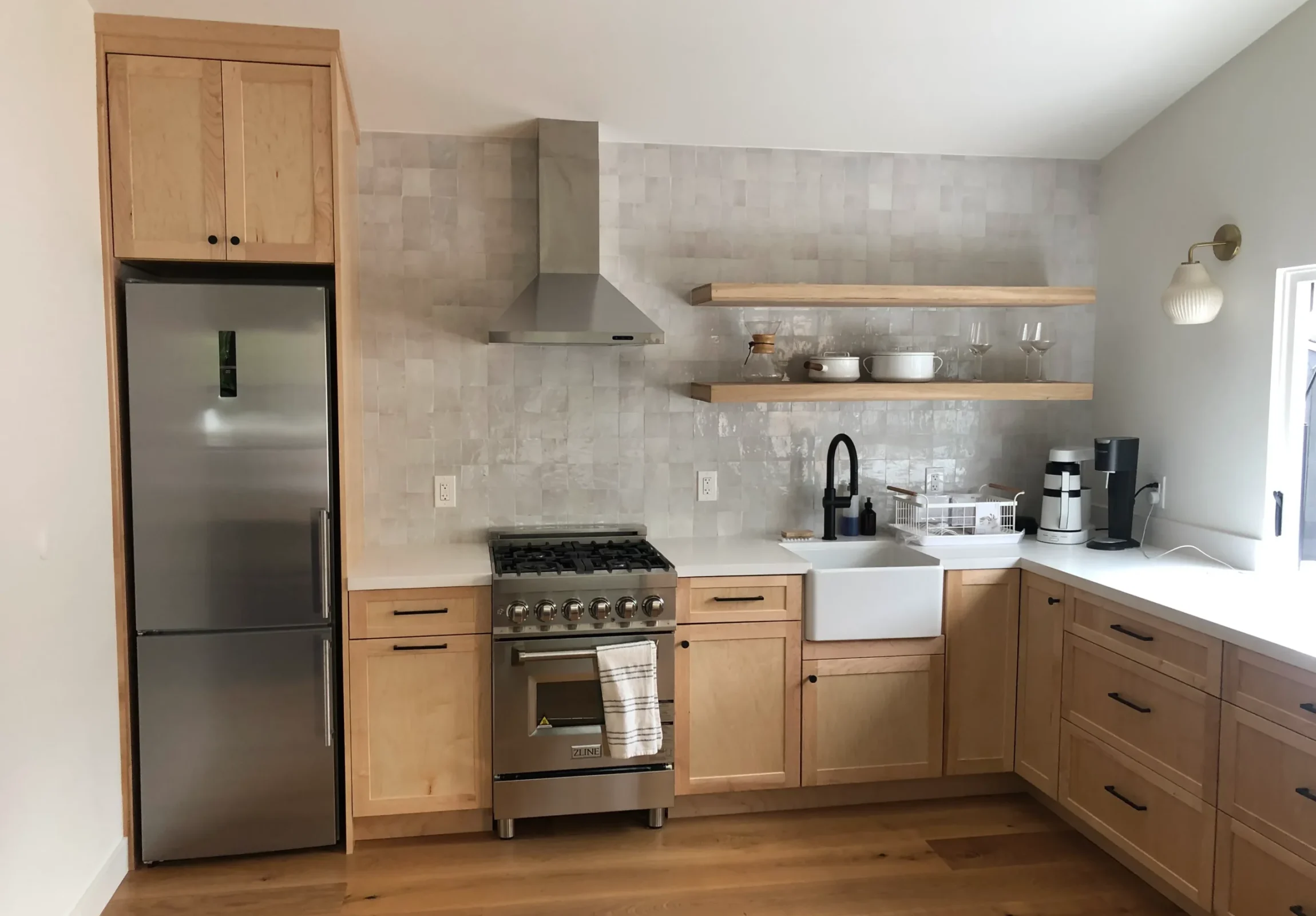 Real kitchen inside an Azure home with wood cabinets and marble tile